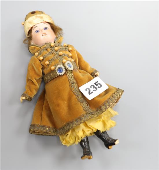 An Armand Marseille doll dressed in Russian dress H.23cm